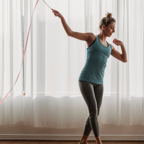 Silhouette of a woman stretching, symbolizing renewed energy and flexibility.